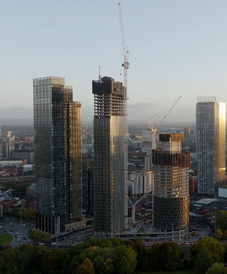 A drone picture of 3 buildings being contructed in Manchester. Sunruise.