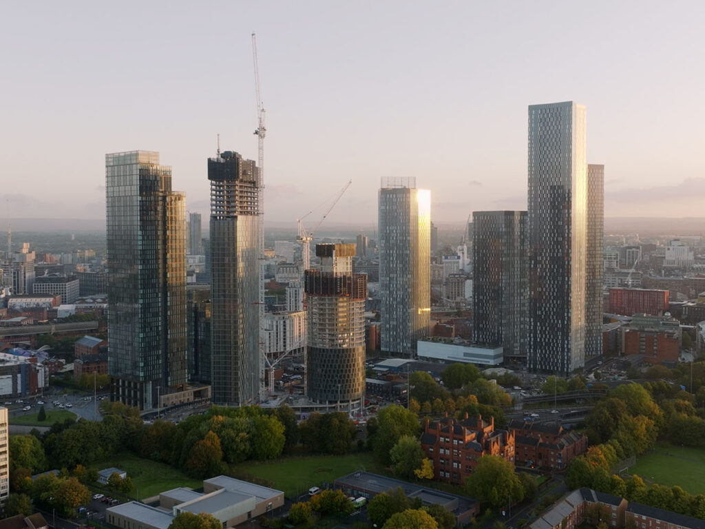 A photo of Manchester's skyline during sunrise in autum. Lots of the buildings are under construction.